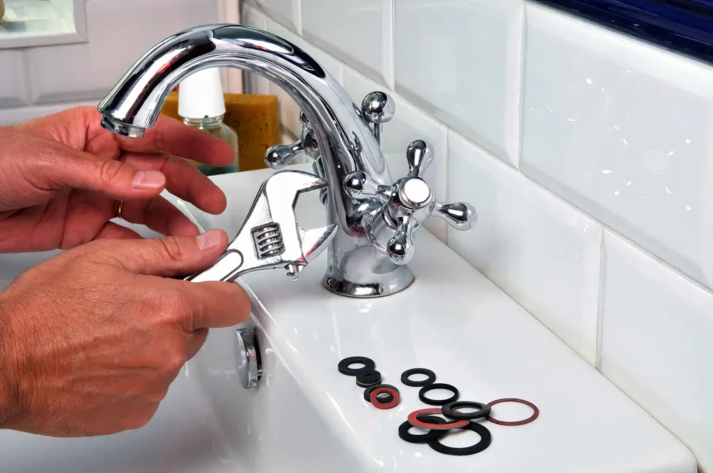 Plumber performing maintenance on a bathroom faucet in Miami