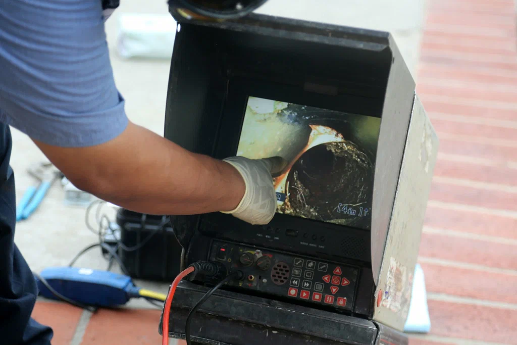 Technician viewing a drain inspection camera in Miami