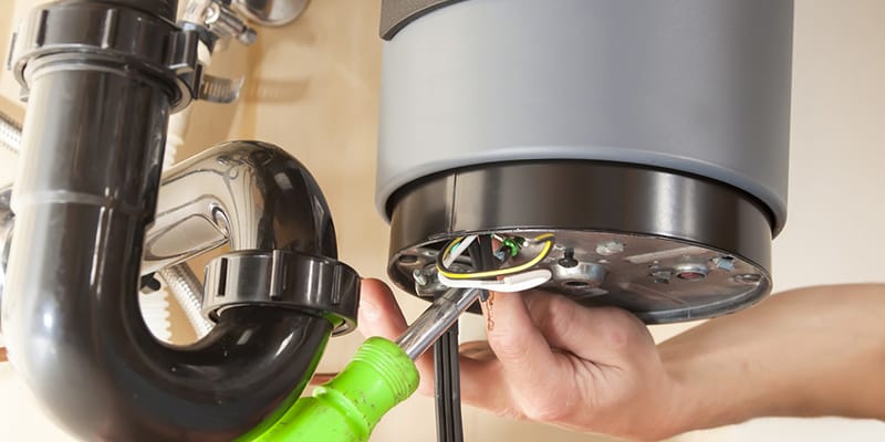 Technician repairing the heating element of a water heater in Miami