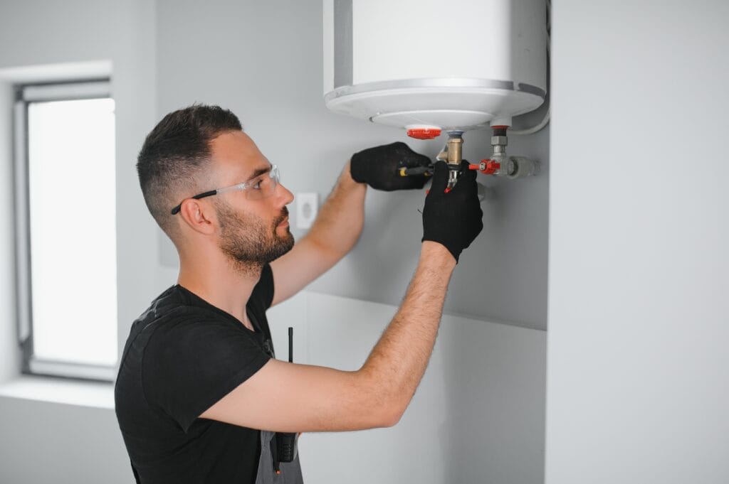 Technician performing water heater maintenance in Miami