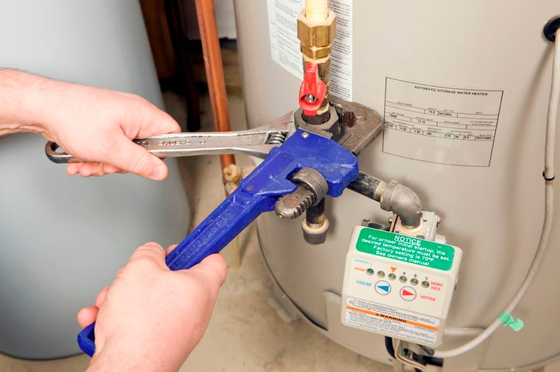 Plumber repairing a water heater valve in Miami